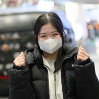 北京首都国際空港に到着し、笑顔でポーズをとる中井亜美＝中国・北京で2026年1月20日、吉田航太撮影