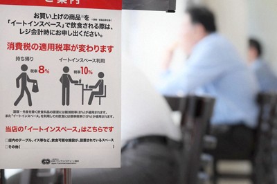 消費税率が引き上げられ、コンビニエンスストア店内で商品を食べるかどうかで税率が変わることを伝える案内＝福岡市博多区で2019年10月1日、津村豊和撮影