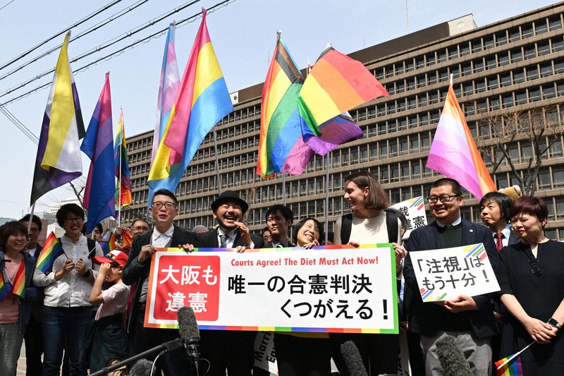 同性婚を認めるよう訴える裁判は各地で起こされている。写真は、大阪高裁による違憲判決後に笑顔を見せる原告ら＝大阪市北区で2025年3月25日午前11時46分、大西岳彦撮影