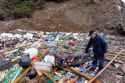 プラスチックや樹木などさまざまなごみが流れ着いた海岸。斜面上部まで拡散している＝長崎県対馬市で2025年12月20日午後3時23分、田中泰義撮影