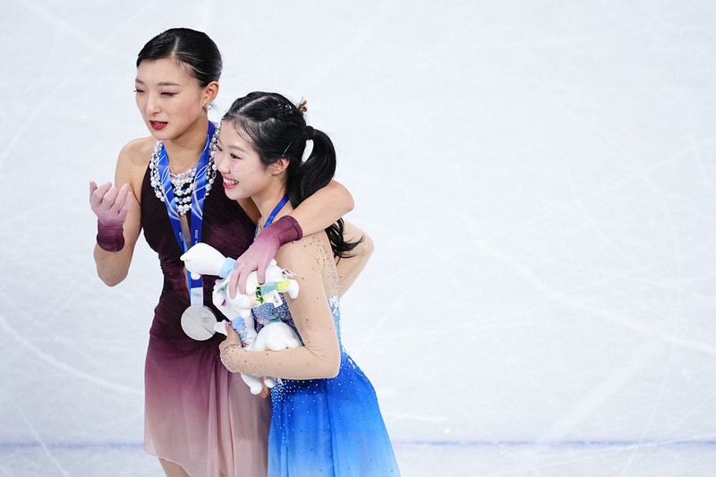 中井亜美（手前）の肩を抱きながら話をする坂本花織＝ミラノ・アイススケートアリーナで2026年2月19日、貝塚太一撮影