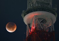 The moon appears copper-red during a total lunar eclipse as seen beside the upper observation deck of Tokyo Tower in the capital's Minato Ward at 2:40 a.m. on Sept. 8, 2025. (Mainichi/Koichiro Tezuka)