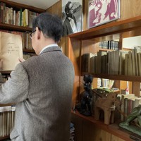 小松左京の書斎で資料を探す、小松の次男実盛さん＝小松左京ライブラリ提供