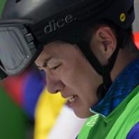 男子スノーボードクロス大腿障害の決勝を終えうつむく小須田潤太＝コルティナ・パラスノーボードパークで2026年3月8日、渡部直樹撮影