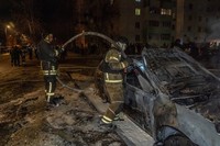 Rescuers put out a fire in a residential neighborhood following a Russian drone attack in Kharkiv, Ukraine, March 9, 2026. (AP Photo/Andrii Marienko)