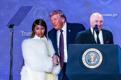 「トランプ口座」のイベントで大統領と握手するラッパーのミナージュさん（左）＝2026年1月、Bloomberg