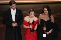 Chris Appelhans, from left, Maggie Kang, and Michelle L.M. Wong accept the award for animated feature film for "K-pop Demon Hunters" during the Oscars, March 15, 2026, at the Dolby Theatre in Los Angeles. (AP Photo/Chris Pizzello)