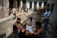 People play dominoes outside during a blackout in Havana, on March 17, 2026. (AP Photo/Ramon Espinosa)