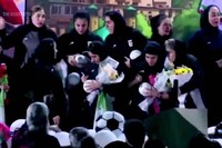 Members of Iran's national women's soccer team autograph soccer balls during a welcome ceremony upon their return to the Islamic Republic in Tehran, March 19, 2026. (Iran Press via AP)
