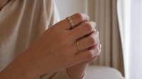 This photo provided by jewelry brand Hakubotan shows two "divorce rings" titled "Yoru -- night" (on the index finger) and "Asa -- morning" (on the ring finger).