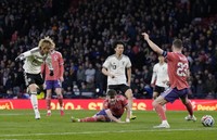 Japan's Junya Ito, left, scores during the second half of an international friendly against Scotland at Hampden Park in Glasgow, Scotland, on March 28, 2026. (Kyodo) 