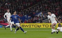 Japan's Kaoru Mitoma, front left, scores during the first half of an international friendly against England at Wembley Stadium in London on March 31, 2026. (Kyodo)