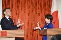 Japanese Prime Minister Sanae Takaichi, right, poses after a joint news conference with French President Emmanuel Macron at the State Guest House, Akasaka Palace, in Tokyo on April 1, 2026. (Pool photo)