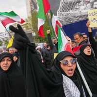 米国やイスラエルとの停戦発表を受け、街中で体制のスローガンを唱える支持者＝イランの首都テヘランで2026年4月8日、AP