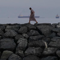 ホルムズ海峡に浮かぶ石油タンカーや貨物船＝アラブ首長国連邦（UAE）から撮影、2026年3月11日、AP