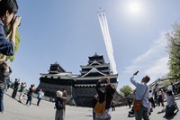 This photo taken with a fish eye lens on April 11, 2026 shows the Air Self-Defense Force's Blue Impulse aerobatic team flying over Kumamoto Castle in Kumamoto. (Kyodo)
