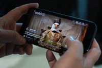 An AI-made viral animation released by Chinese state media mocking the United States as a white eagle is seen on a mobile phone in Beijing, China, Monday, April 6, 2026. (AP Photo/Ng Han Guan)