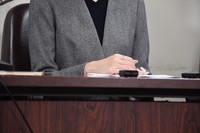 The wife of a married couple who say their landlord suddenly raised their rent holds a press conference following the verdict in her lawsuit in November 2025. (Kyodo)