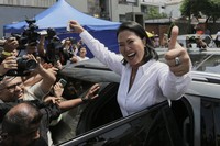 Keiko Fujimori, presidential candidate of the Popular Force party, departs a polling station after voting during general elections in Lima, Peru, April 12, 2026. (AP Photo/Gerardo Marin)