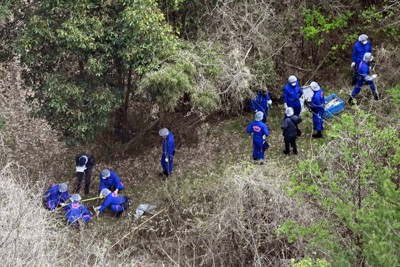 子どもとみられる遺体が見つかった現場周辺を調べる捜査員ら＝京都府南丹市で2026年4月14日午前10時2分、本社ヘリから大西岳彦撮影