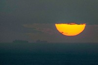 Ships sail through the Arabian Gulf toward the Strait of Hormuz as the sun sets in the United Arab Emirates, March 23, 2026. (AP Photo, File)