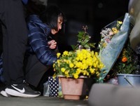 Shinobu Yamato, who lost her son Hikaru in the massive quake in Kumamoto Prefecture 10 years ago, remembers him and offers an incense stick in the village of Minamiaso on April 16, 2026. (Kyodo)