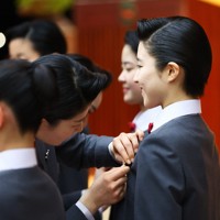 宝塚音楽学校の入学式で、本科生から校章バッジを贈呈される新入生＝兵庫県宝塚市で2026年4月18日午前10時44分、前田梨里子撮影