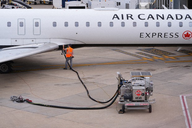 A worker fuels an Air Canada jet at DFW International Airport in Grapevine, Texas, April 14, 2026. (AP Photo/LM Otero, File)