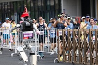 Runners take pictures of a humanoid robot in the second Beijing E-Town Half Marathon and Humanoid Robot Half Marathon in Beijing, April 19, 2026. (Haruna Furuhashi/Pool Photo via AP)