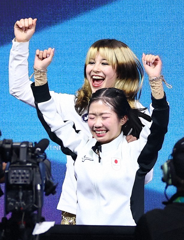 ミラノ五輪の女子で銅メダルが確定し、喜ぶ中井亜美選手（手前）と、金メダルとなった米国のアリサ・リュウ選手＝ミラノ・アイススケートアリーナで2026年2月19日、猪飼健史撮影