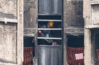 A resident of Wang Fuk Court retrieves belongings five months after the deadly fire in Hong Kong. April 20, 2026. (AP Photo/Chan Long Hei)
