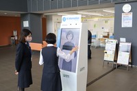 A visitor interacts with the AI avatar device installed at the main entrance of Shiroi City Hall in Chiba Prefecture on April 20, 2026. (Mainichi/Hiroshi Ishikawa)