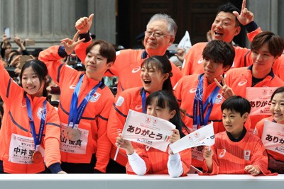 ミラノ・コルティナ冬季オリンピック・パラリンピック日本選手団の応援感謝イベントで、日本橋の街を練り歩き観客の声援に応える（左から）フィギュア女子の中井亜美さん、男子の鍵山優真さん、女子の坂本花織さん、男子の佐藤駿さんら選手たち＝東京都中央区で2026年4月25日午前10時4分、滝川大貴撮影
