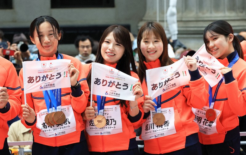 ミラノ・コルティナ冬季オリンピック・パラリンピック日本選手団の応援感謝イベントで、日本橋の街を練り歩き観客の声援に応えるスピードスケート女子の（左から）高木美帆さん、佐藤綾乃さん、堀川桃香さん、野明花菜さん＝東京都中央区で2026年4月25日午前9時49分、滝川大貴撮影