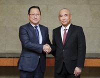 This supplied photo shows Jun Seki, left, chief strategy officer for electric vehicles at Hon Hai Precision Industry Co., and Kazunori Tanaka, head of automotive equipment business at Mitsubishi Electric Corp. (Photo courtesy of Mitsubishi Electric Corp.)(Kyodo) 
