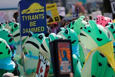 トランプ米政権に抗議する「ノー・キングス」デモにカエルの着ぐるみ姿で参加する人々＝米西部オレゴン州ポートランドで3月28日、ロイター