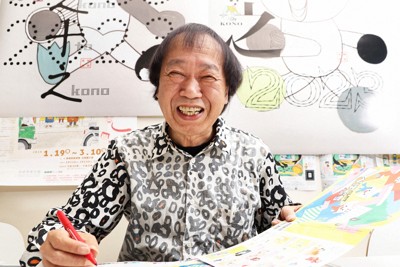 笑顔でポーズをとるブックデザイナーの祖父江慎さん＝東京都目黒区で2023年11月28日、玉城達郎撮影