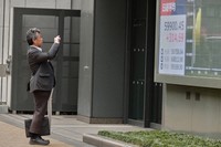 A person takes a photo of an electronic stock board showing Japan's Nikkei index outside a securities firm, April 23, 2026, in Tokyo. (AP Photo/Eugene Hoshiko)