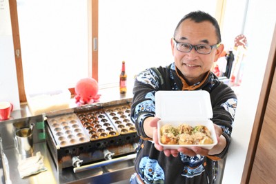 焼き上げたたこ焼きを手にする大西健太郎さん。口にすると舌の上で生地がとろける＝神奈川県三浦市で2026年1月21日、内藤絵美撮影