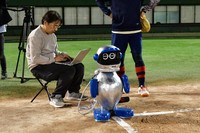 Takashi Yoshida adjusts the second version of his robot umpire at Gosando Nanko baseball field in Osaka's Suminoe Ward, Nov. 14, 2025. (Mainichi)