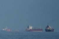 Oil tankers and cargo ships line up in the Strait of Hormuz as seen from Khor Fakkan, United Arab Emirates, March 11, 2026. (AP Photo/Altaf Qadri,File)