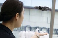 A clerk operates a drone at a shop in Beijing on April 27, 2026. (Kyodo)
