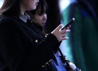 This photo taken on Feb. 20, 2025, shows a person with a smartphone in Tokyo. (Kyodo)
