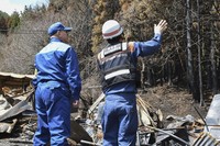 Otsuchi Mayor Kozo Hirano, left, visits an area hit by wildfire in Otsuchi, Iwate Prefecture, on May 2, 2026. (Kyodo)