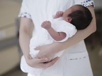 This file photo taken in February 2025 shows a newborn baby at a hospital in Aichi Prefecture. (Kyodo)