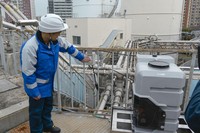 This photo shows Osaka Gas Co.'s demonstration experiment to convert used bioplastic bento containers into energy in Osaka Prefecture, Dec. 17, 2025. (Kyodo) 