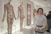 Japanese designer Tamae Hirokawa, photographed during a press event at the Metropolitan Museum of Art on May 4, 2026, poses by garments she designed that were selected for the New York museum's upcoming Costume Art exhibition. (Kyodo) 
