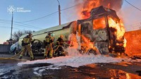 In this photo provided by the Ukrainian Emergency Service, emergency services personnel work to extinguish a burning vehicle following a Russian drone attack in the Kyiv region, Ukraine, May 5, 2026. (Ukrainian Emergency Service via AP)