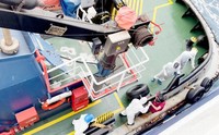 Health workers get off the Dutch-flagged MV Hondius, a cruise ship carrying nearly 150 people as it remains off Cape Verde on May 4, 2026 after three passengers died and several others fell seriously ill in a suspected hantavirus outbreak. (Qasem Elhato via AP)