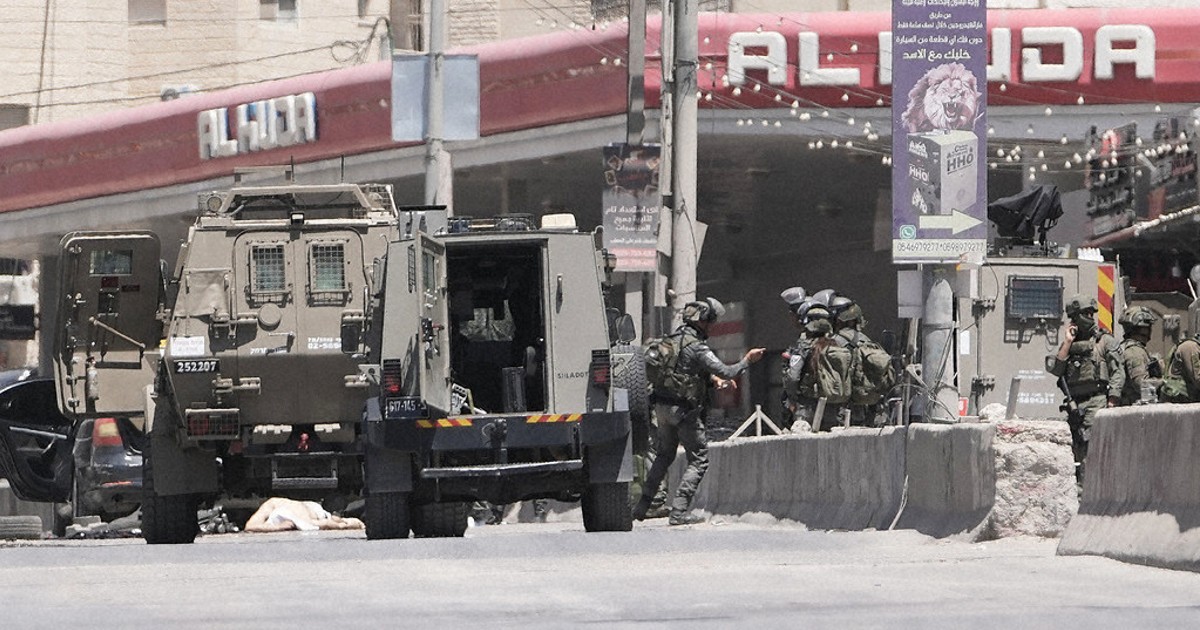 Israel's military said a Palestinian family could bury their father. Then the settlers arrived